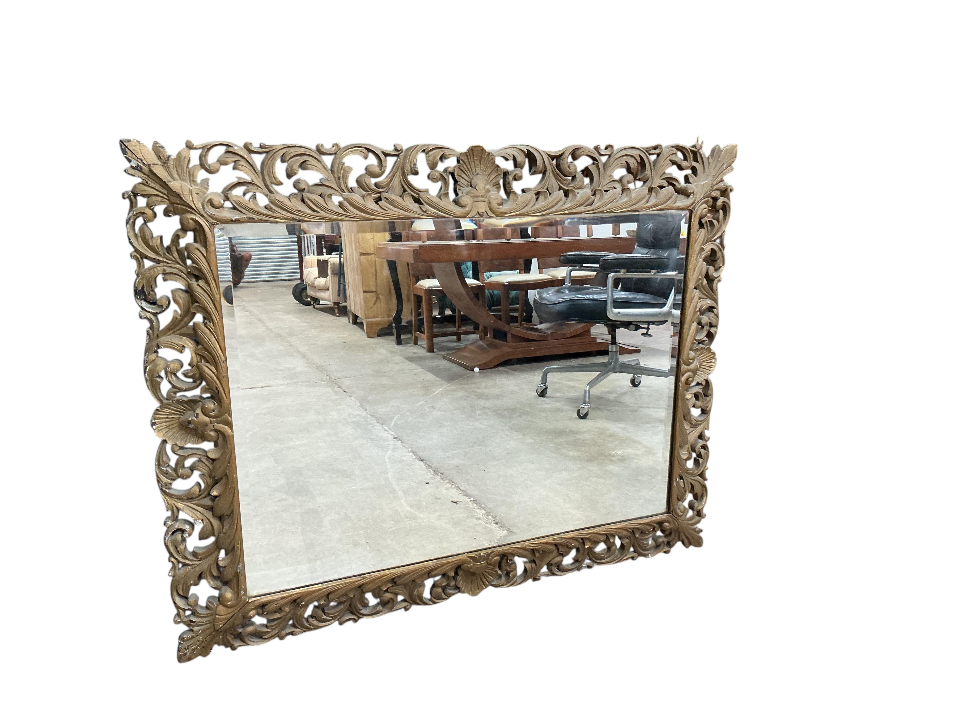 A large late 19th / early 20th century rectangular carved giltwood wall mirror, width 97cm, height 124cm